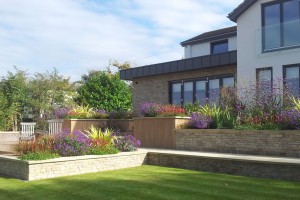 COTSWOLD STONE RAISED BEDS AND STONE CLADDING TO HOUSE CHELTENHAM GLOUCESTERSHIRE