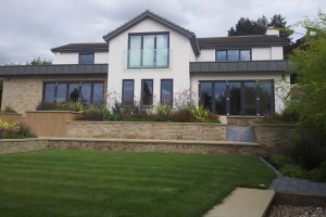 COTSWOLD STONE RAISED BORDERS CONTEMPORARY HOUSE CHELTENHAM GLOUCESTERSHIRE